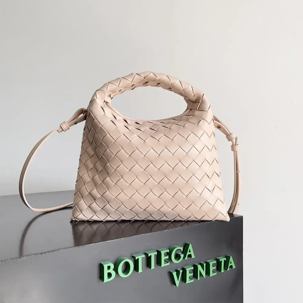 Close-up of woven leather detail and gold hardware on the Mini Hop pink bag