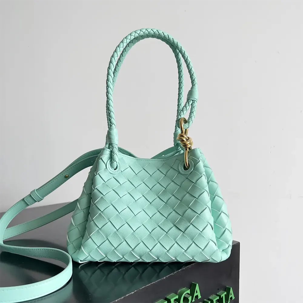 Close-up on aqua intrecciato leather texture of Bottega Veneta Small Andiamo bag