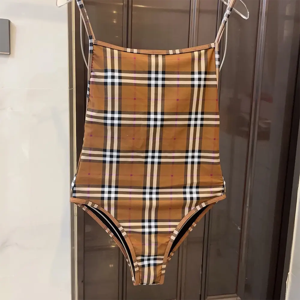 Close-up of fabric and branded hardware on Burberry Women Check Swimsuit