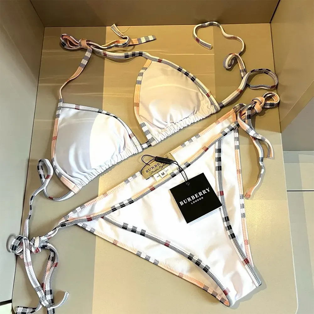 Close-up detail of Burberry check trim on the white bikini fabric