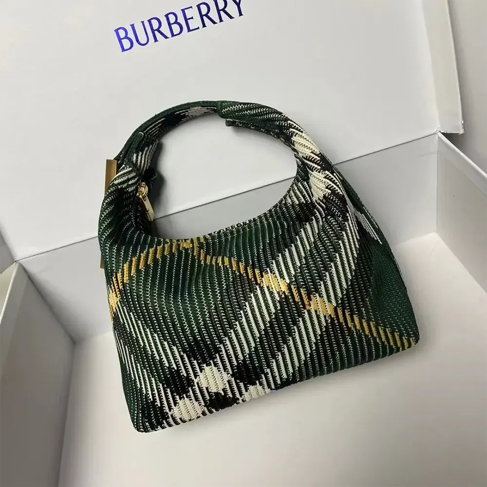 Close-up of Burberry signature check detail on Mini Peg Duffle Bag-Green