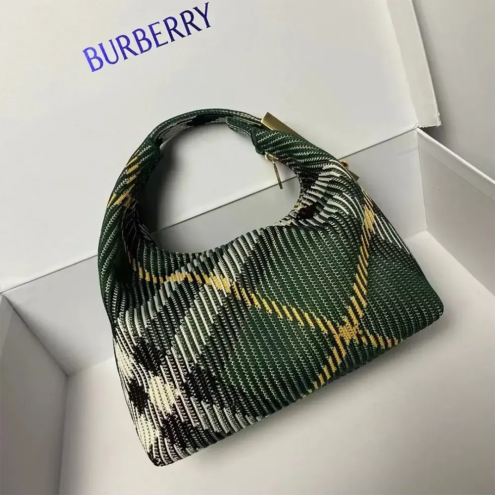 Side angle highlighting antique gold hardware on Burberry Women Mini Peg Duffle Bag-Green