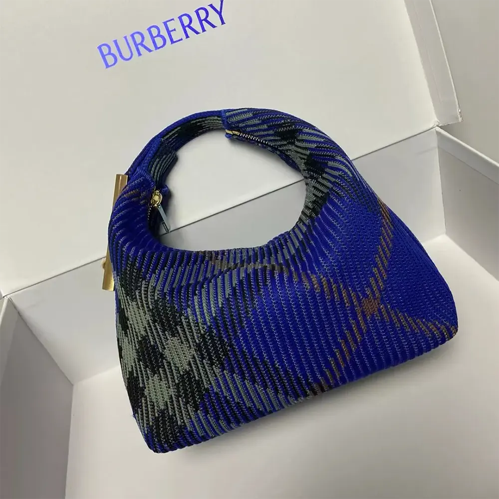 Close-up of gold-tone hardware and Burberry logo on mini peg duffle bag