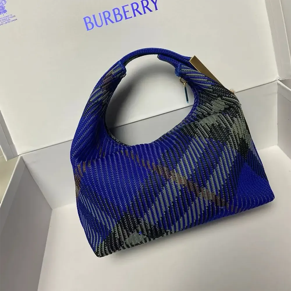 Side angle of Burberry Women Mini Peg Duffle Bag-Navy highlighting silhouette