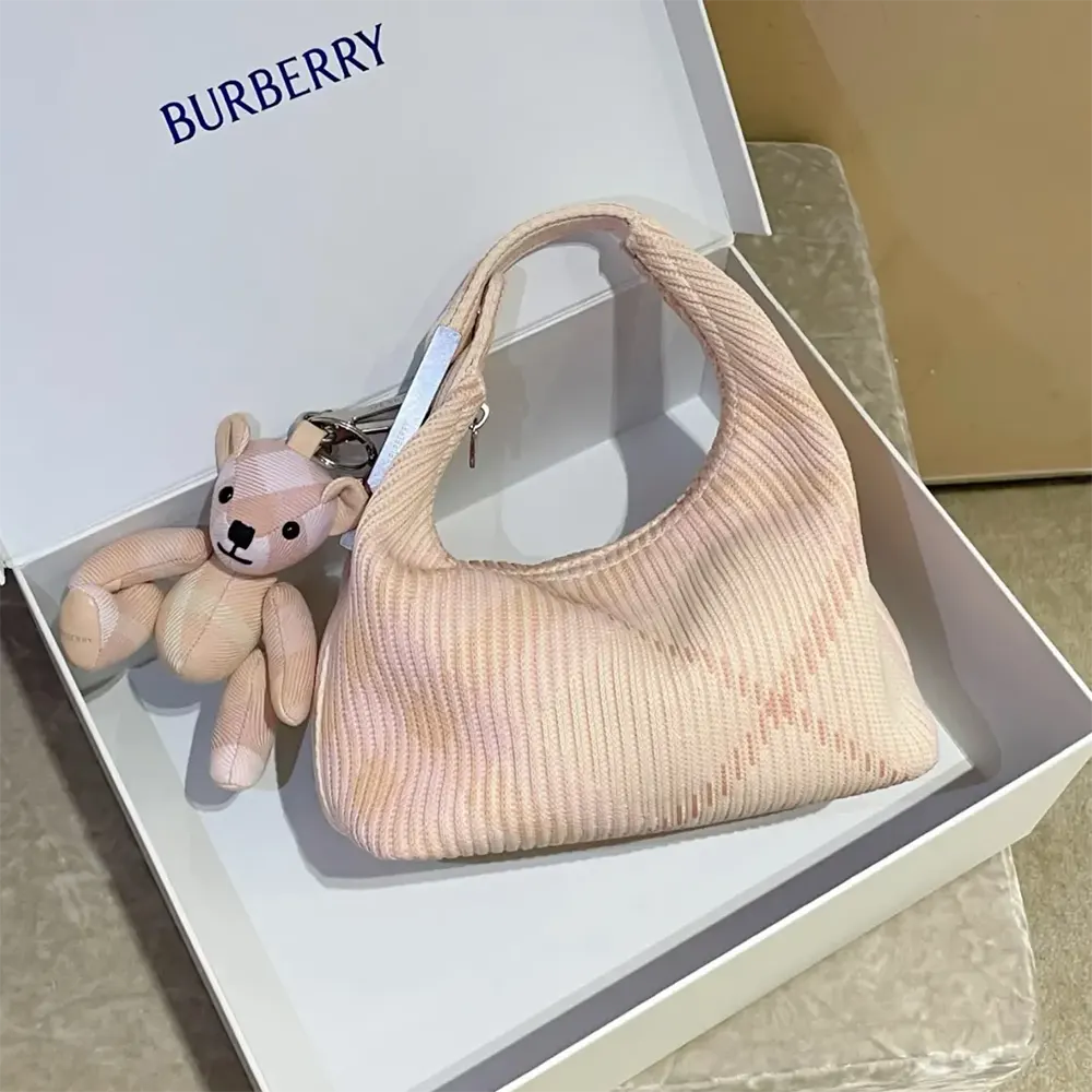 Close-up of gold hardware and signature check detail on Burberry bag