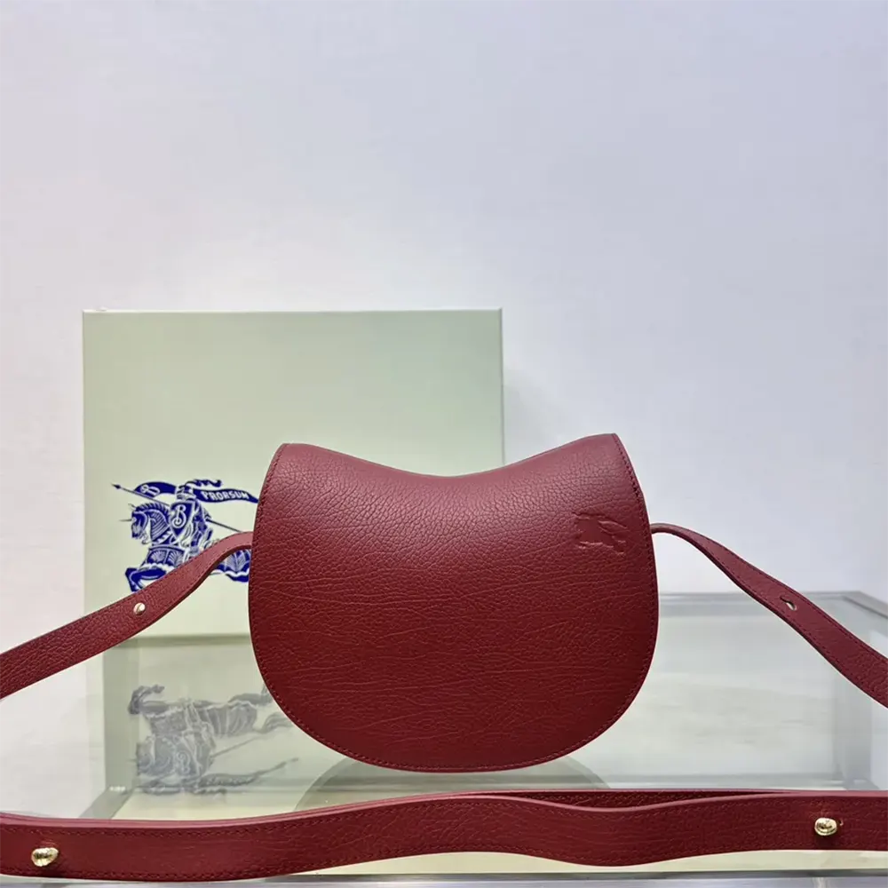 Side profile showing adjustable strap and maroon leather texture