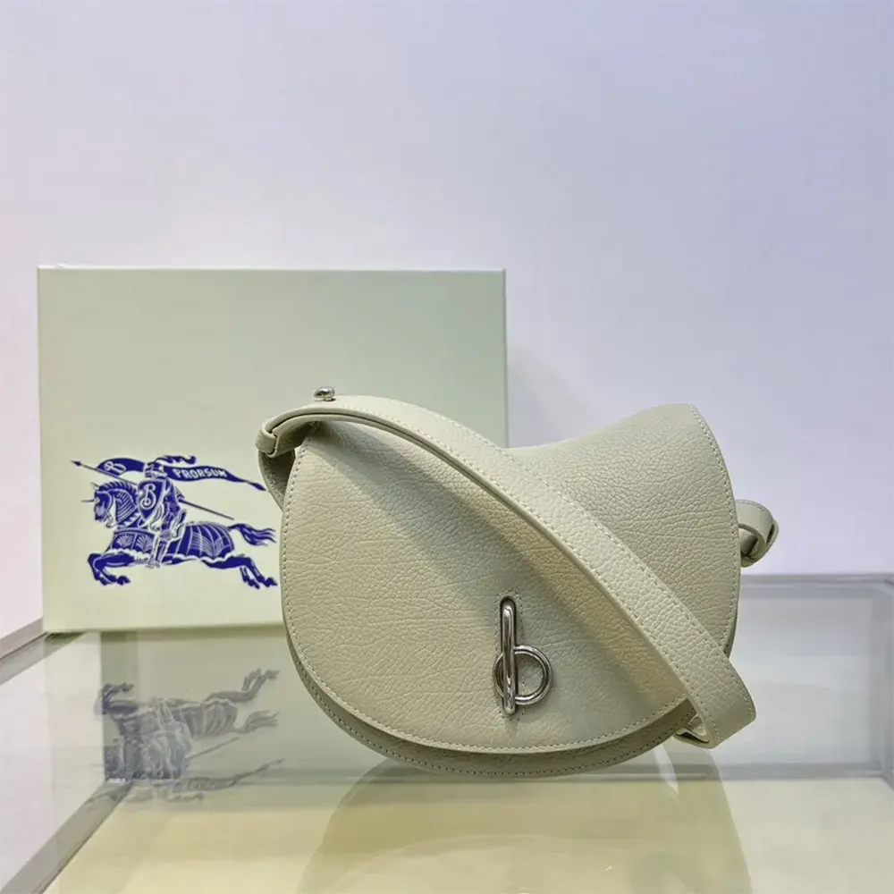 Close-up on gold-tone rocking horse detail on Burberry Women Mini Rocking Horse Bag-White