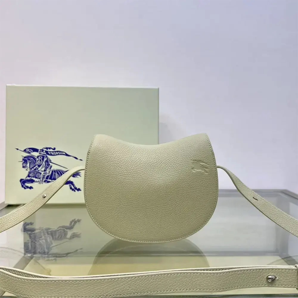 Side angle showing white leather texture of Burberry Women Mini Rocking Horse Bag-White