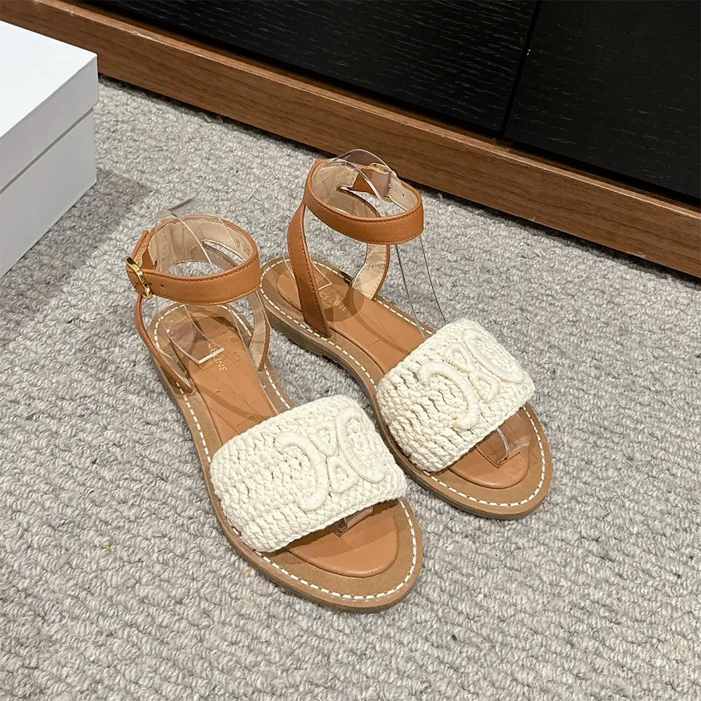 Close-up of gold-tone Celine logo on Lympia Sandal white leather strap