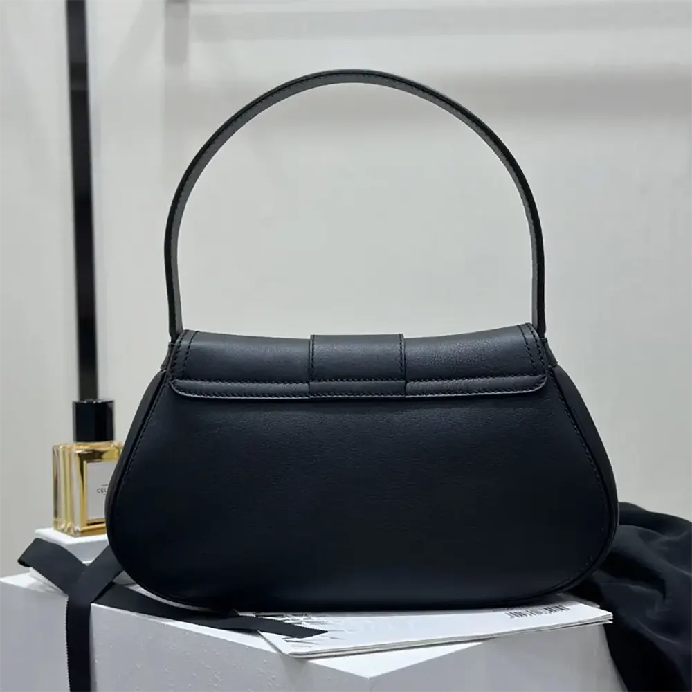 Side angle showing silhouette of Celine Women Medium Polly Bag in black leather