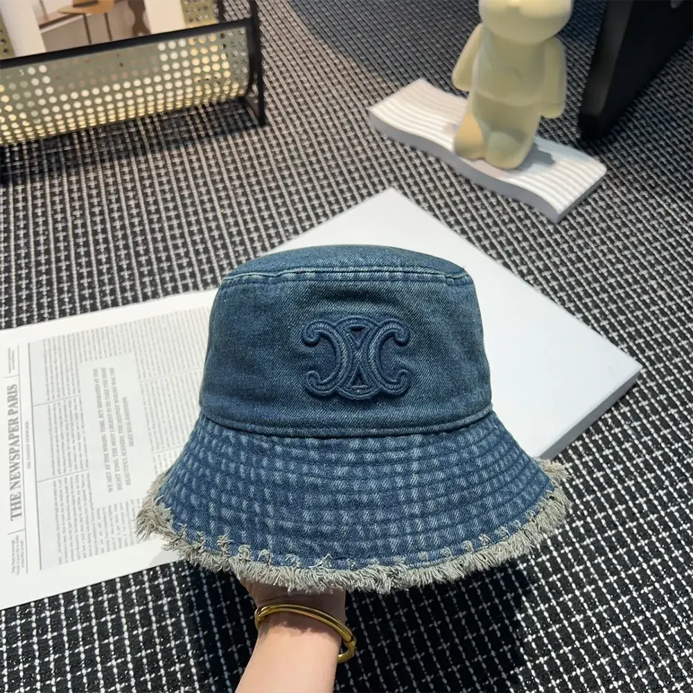 Close-up on signature Triomphe hardware detail on Celine bucket hat