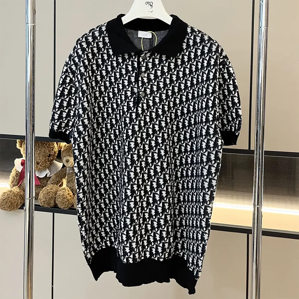 Close-up detail of Dior signature jacquard pattern on black polo shirt