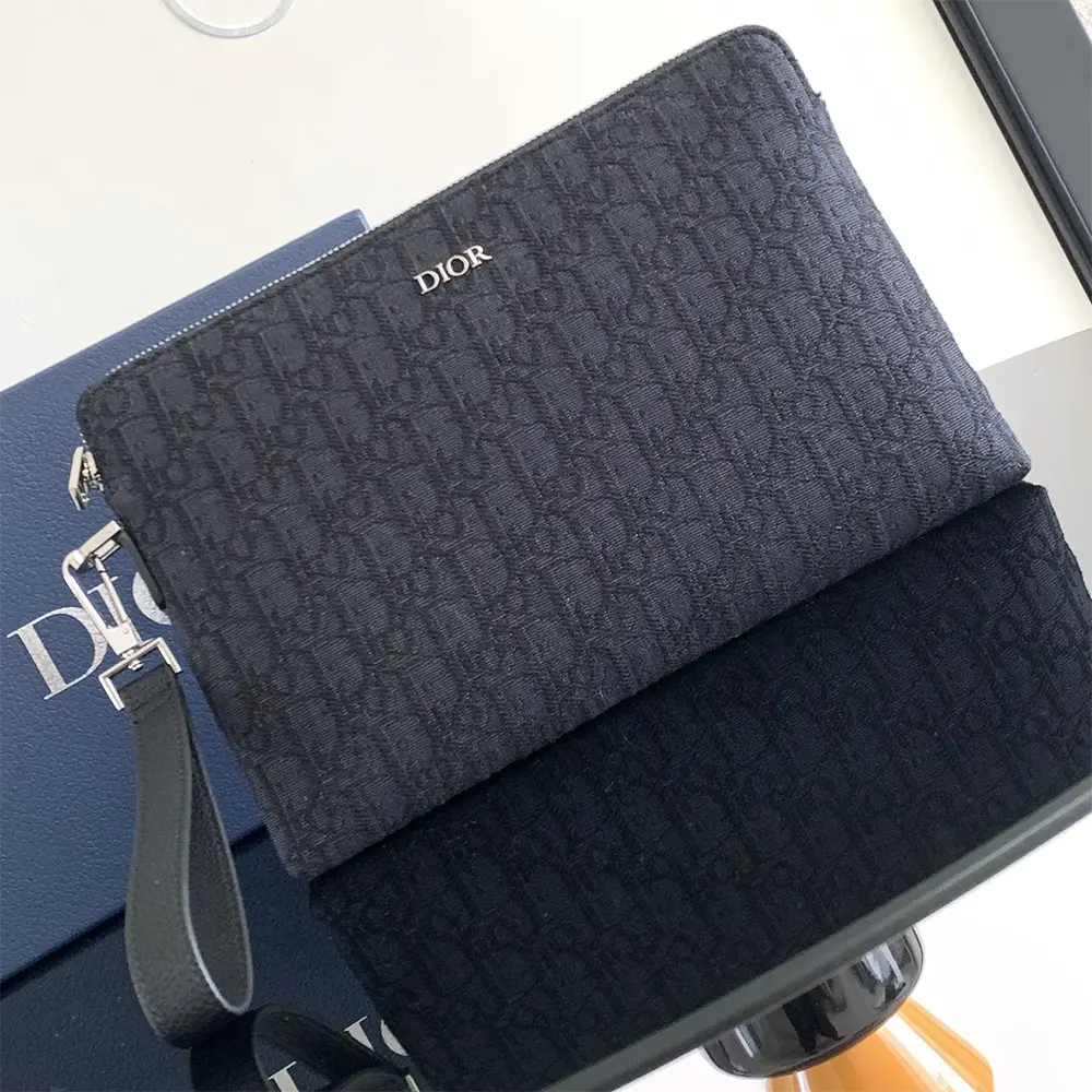 Close-up detail of black Dior Oblique jacquard fabric and silver hardware