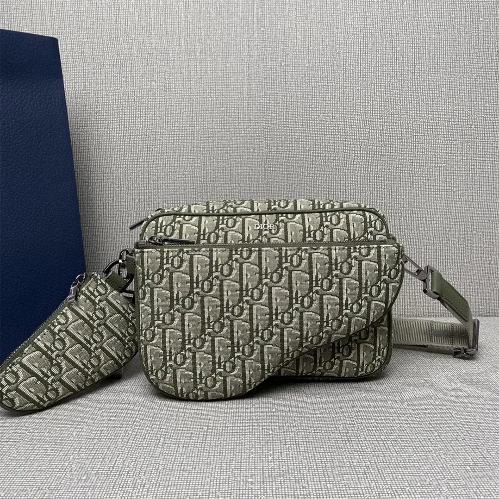 Close-up of dark green jacquard fabric and matte black zipper on Dior Men Saddle Triple Pouch
