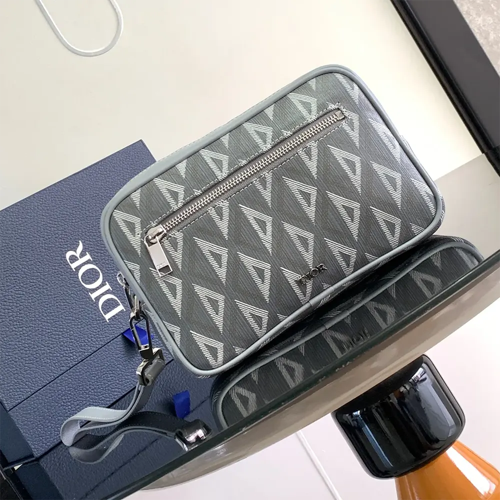 Close-up of silver-tone CD hardware on Dior Men Toiletry Bag