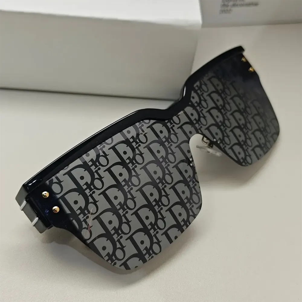 Close-up of blue Dior Oblique pattern on DiorClub M4U mask sunglasses frame