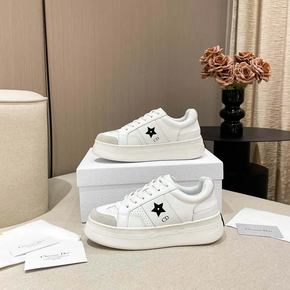 Close-up on silver Dior Star detail on white platform sneaker