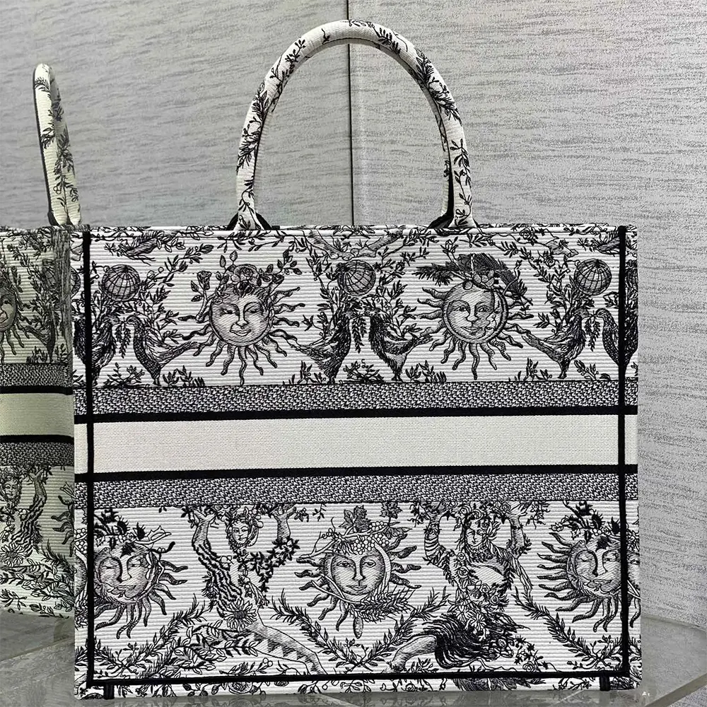 Side angle showing black leather handles of Dior Women Large Dior Book Tote