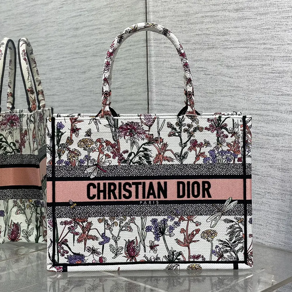 Close-up of multicolor Dior Herbarium embroidery detail on white tote
