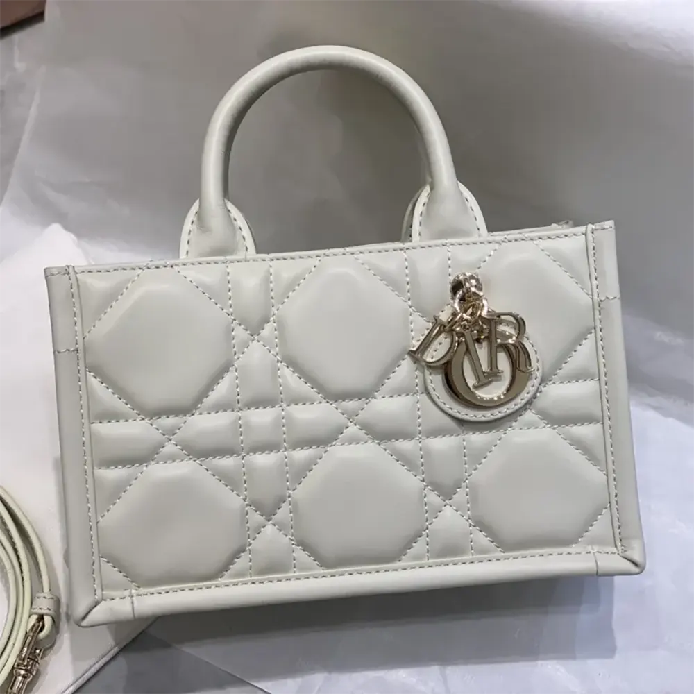 Side angle showing compact silhouette of Dior Women Mini Dior Book Tote Latte Macrocannage Calfskin