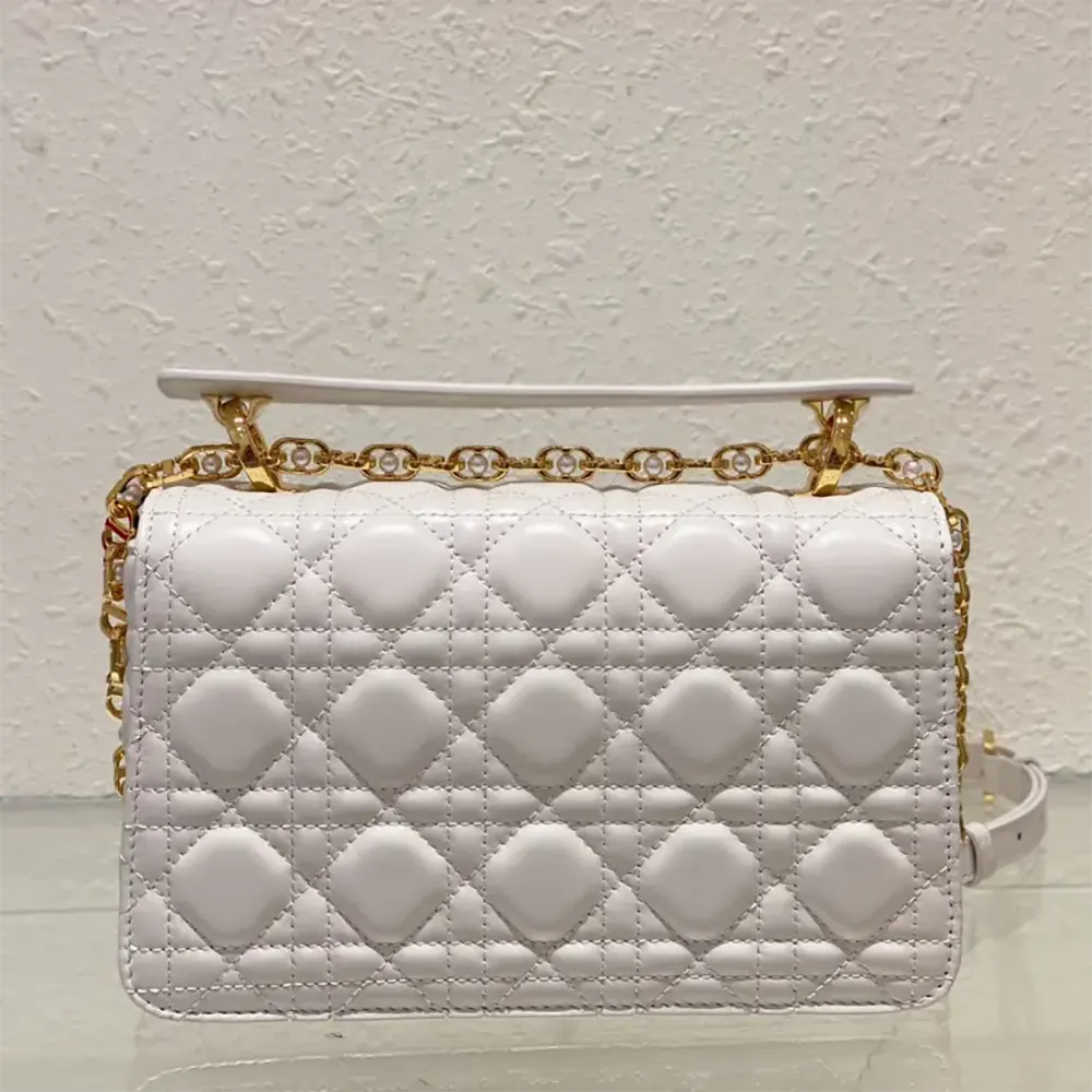 Side profile showing structured silhouette of Dior Women Small Dior Jolie Top Handle Bag