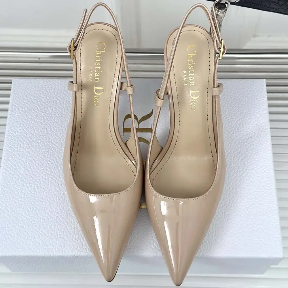 Close-up of Dior Tribales metal detail on nude patent slingback pump