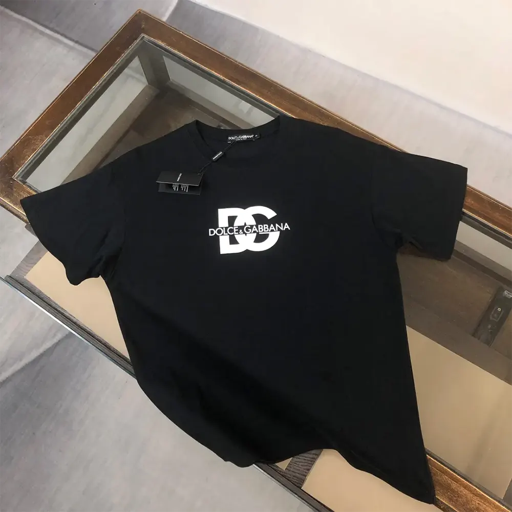 Close-up of DG logo print detail on black Dolce Gabbana D&G t-shirt