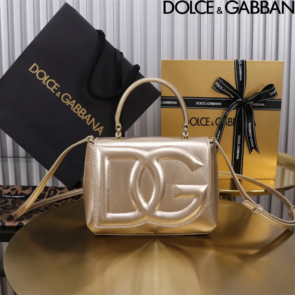 Close-up of gold-tone DG logo hardware on Dolce Gabbana D&G bag