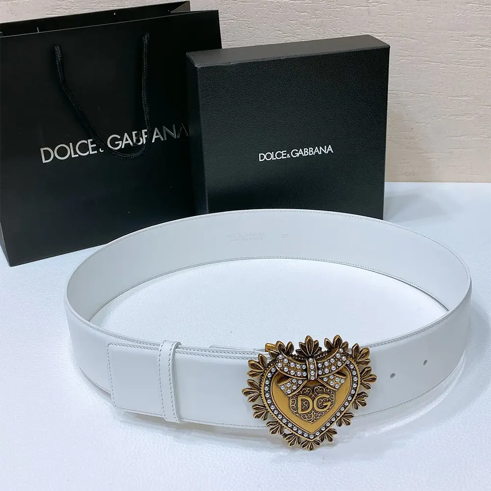 Close-up detail of signature Devotion buckle on white leather belt
