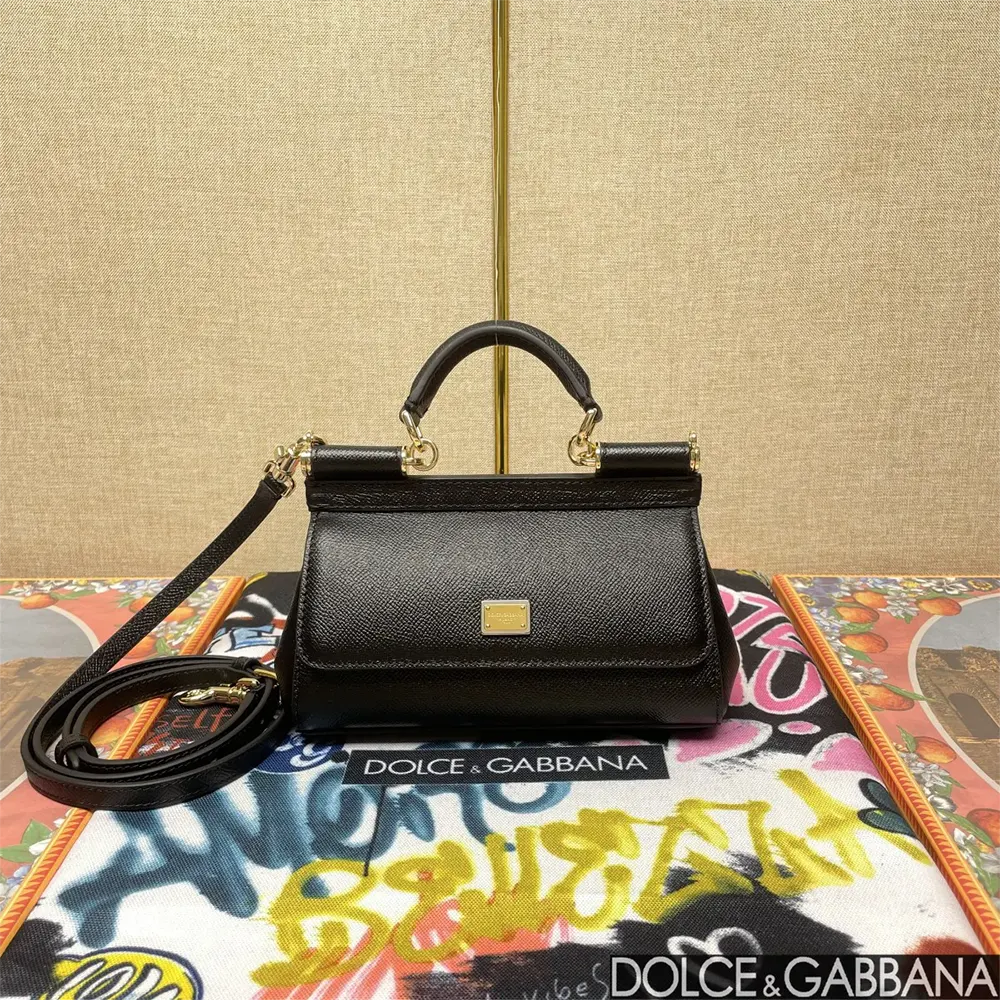 Close-up of gold-tone D&G logo clasp on black Sicily handbag