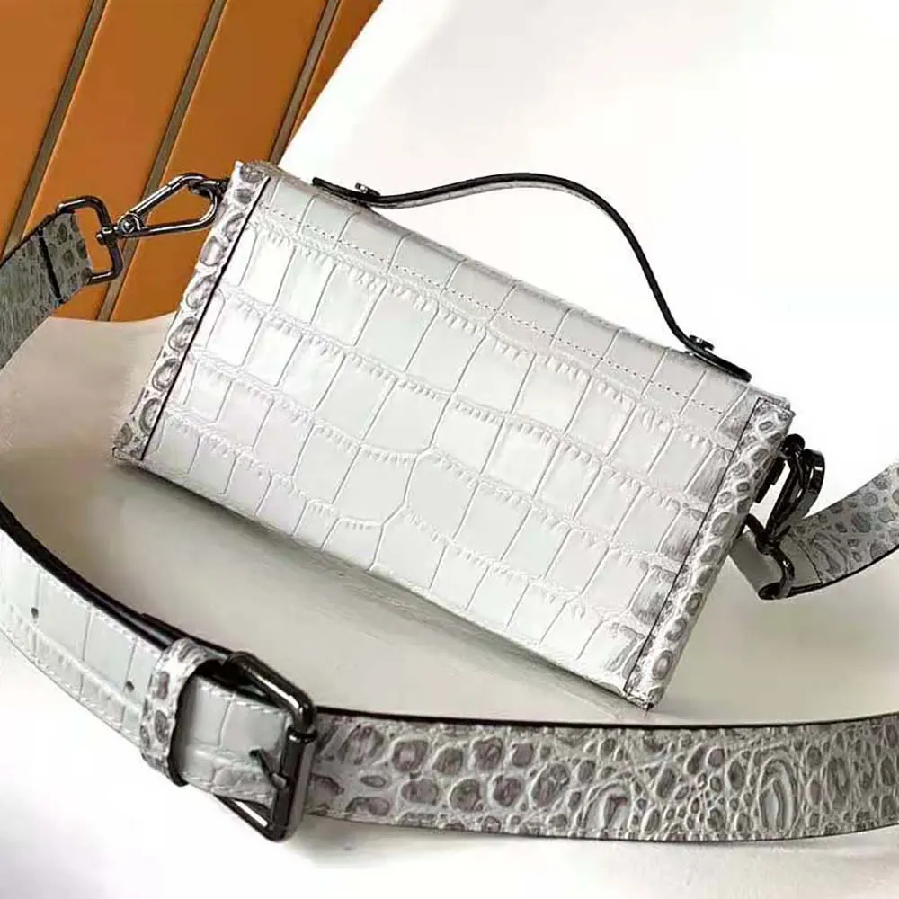 Side angle showing strap and texture of Fendi Men Soft Trunk Baguette White Nuanced Crocodile Leather Bag