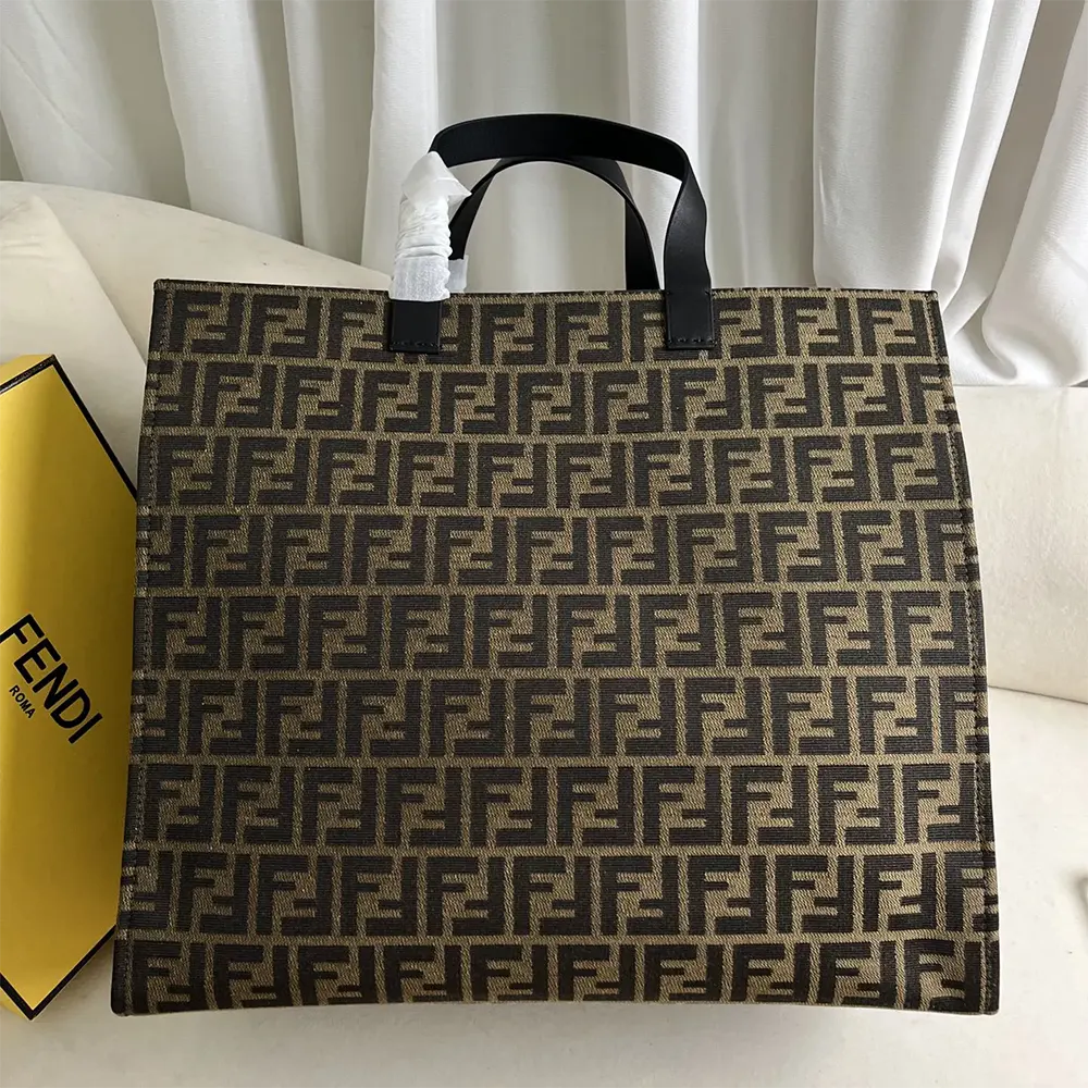 Side angle showing silhouette and handles of Fendi Unisex Shopper FENDI x FRGMT x POKÉMON Brown FF Fabric Bag
