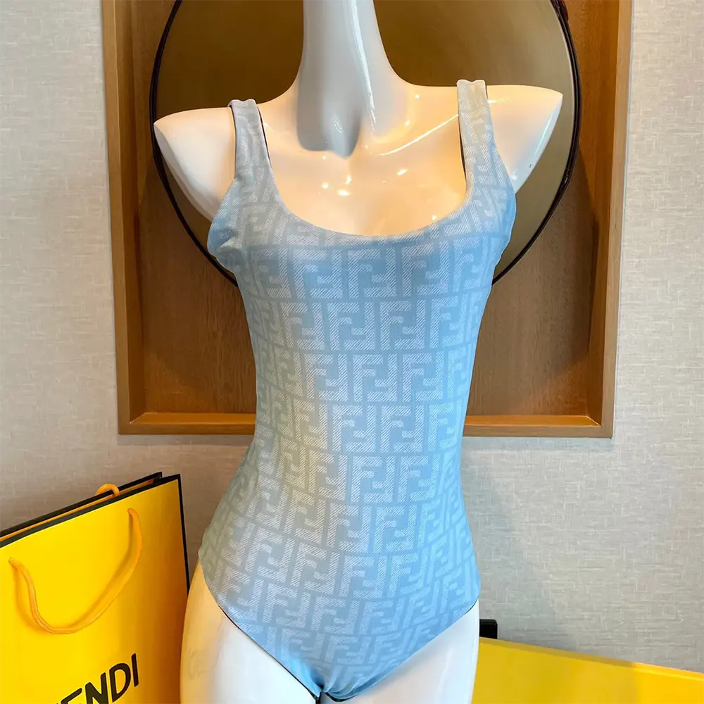 Close-up of Fendi logo hardware on blue Lycra® reversible swimsuit
