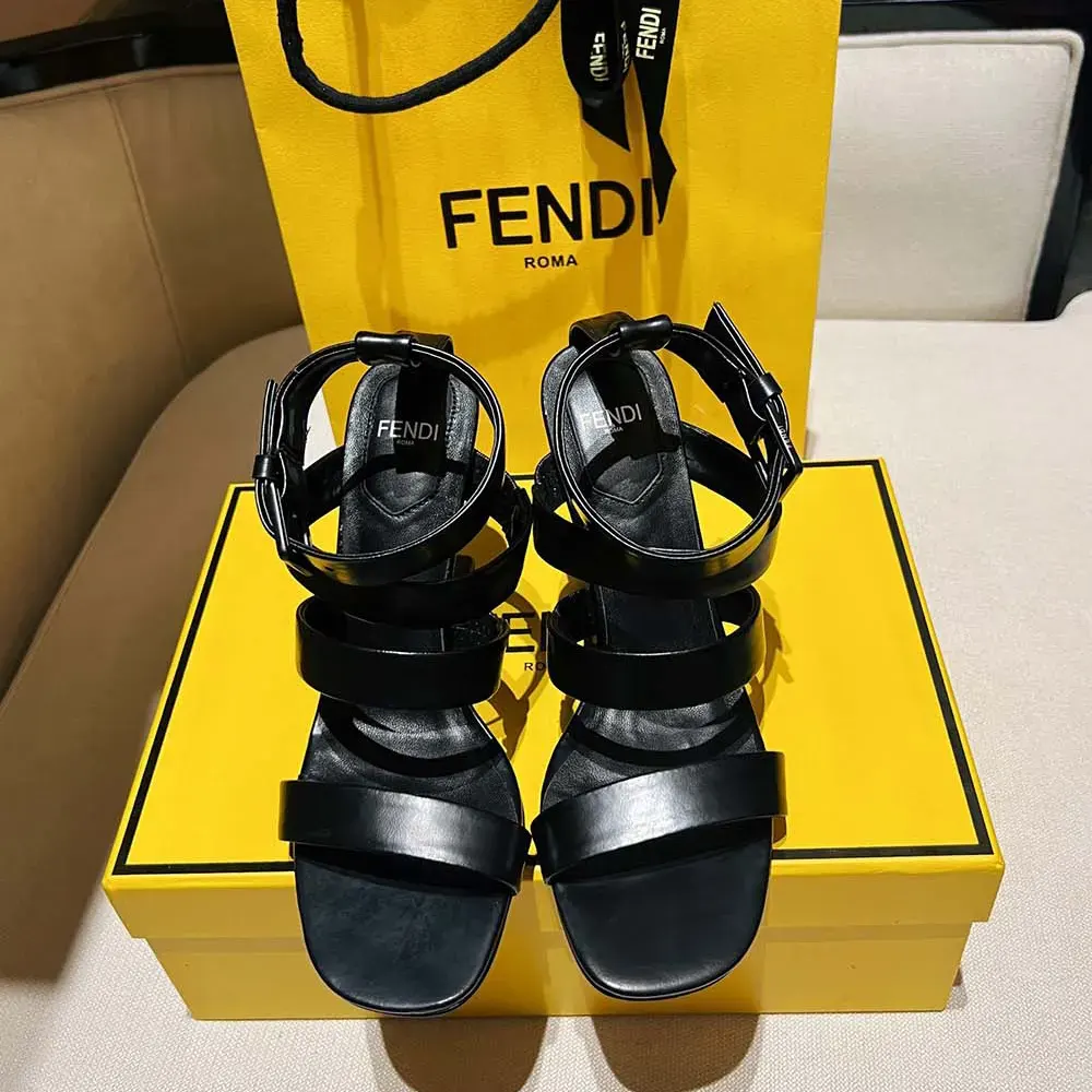 Close-up on gold-tone logo hardware on Fendi Women First sandals