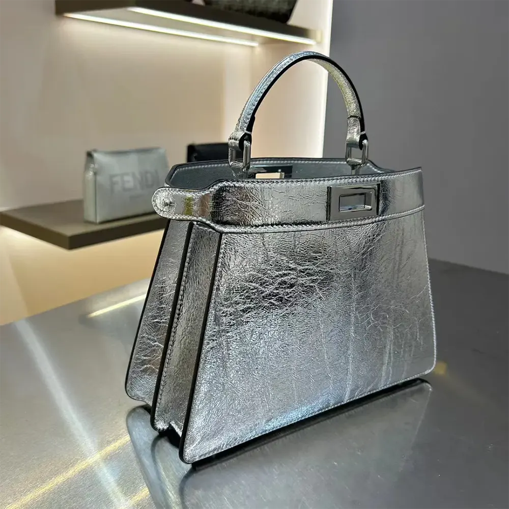Side angle showing gold hardware and compact silhouette of Fendi Peekaboo ISeeU Bag