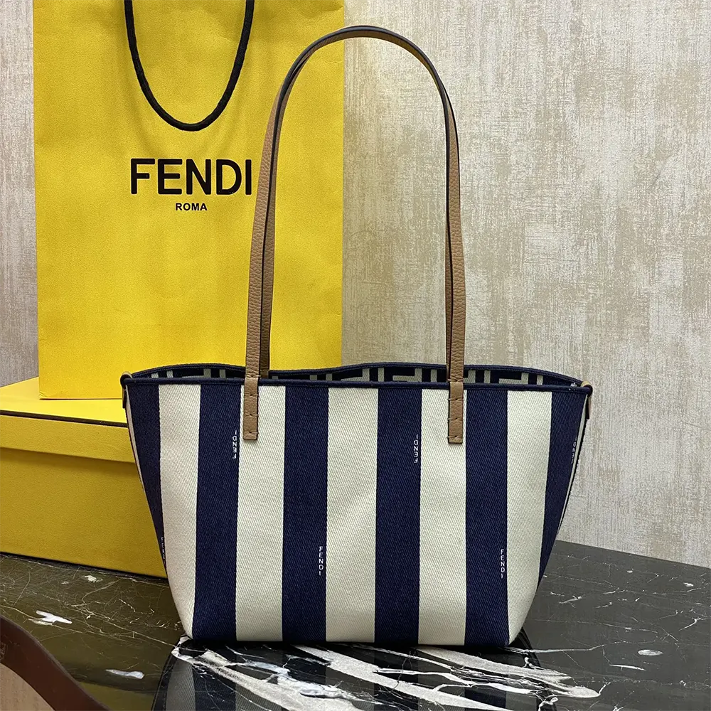 Close-up of gold-tone hardware on Fendi Women Small Roll Reversible Shopper