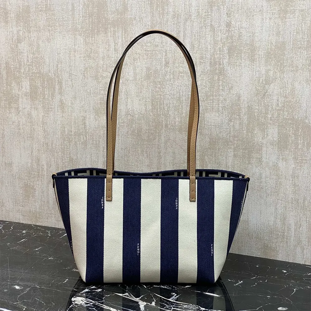 Side angle of Fendi Women Small Roll Reversible Shopper in midnight blue fabric
