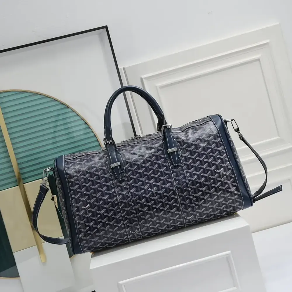 Close-up of navy Goyard coated canvas and leather trim detail
