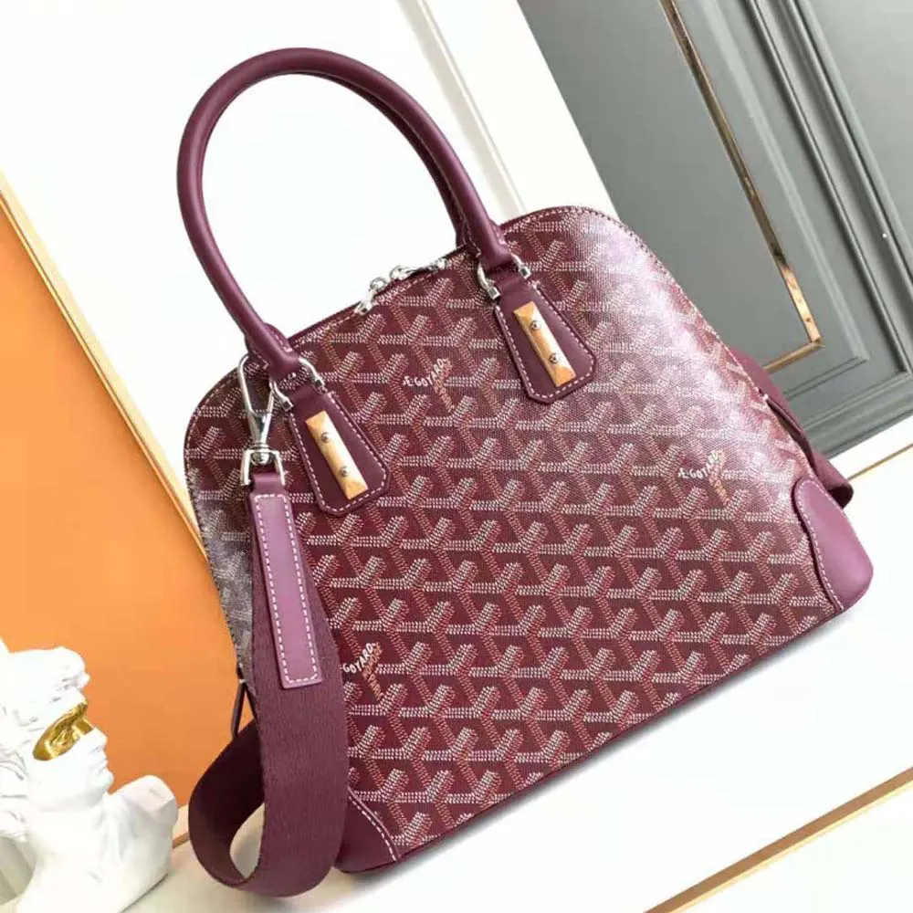 Close-up of gold hardware and leather trim on Goyard Women Vendôme PM Bag-Maroon