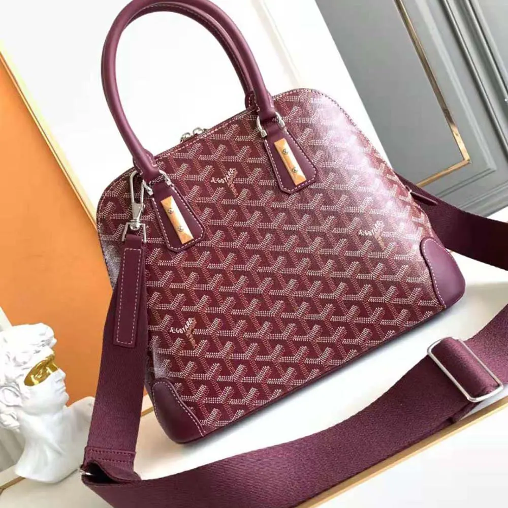 Side angle of Goyard Women Vendôme PM Bag-Maroon highlighting compact silhouette