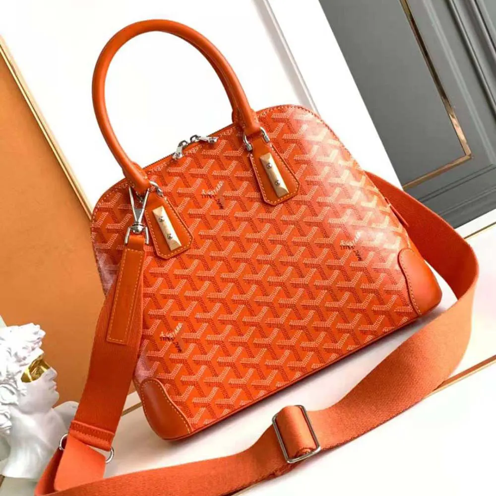 Side angle showing gold-tone hardware on Goyard Women Vendôme PM Bag-Orange