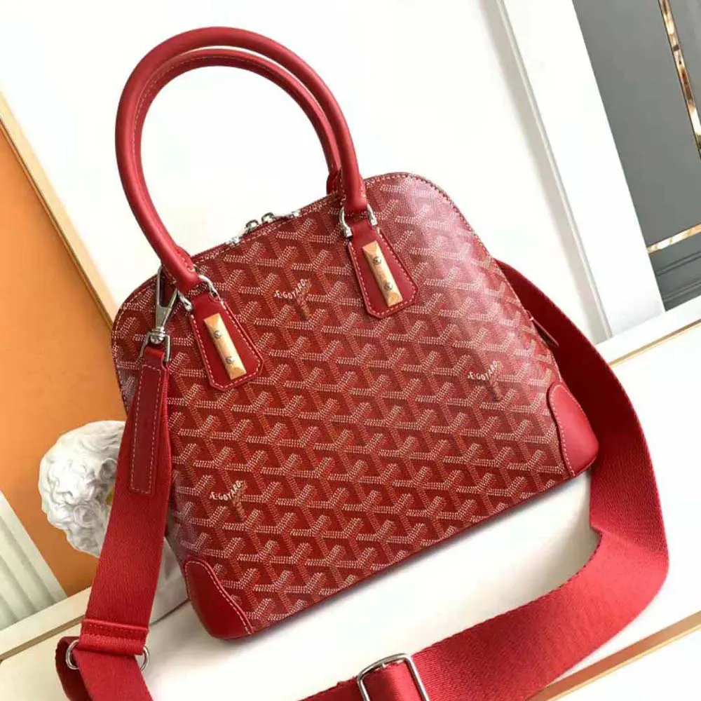 Close-up detail of red coated canvas and gold hardware on Goyard Vendôme PM