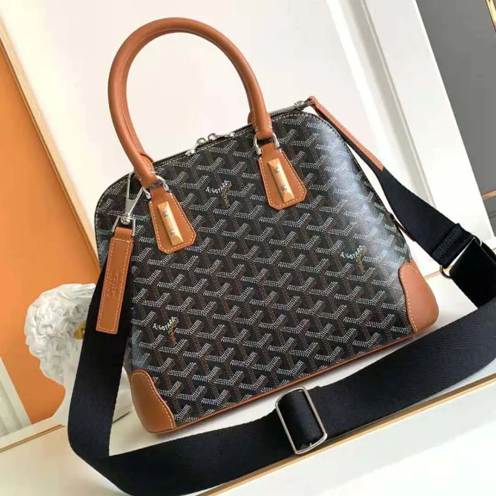 Close-up of tan leather trim and brass hardware on Goyard Vendôme PM