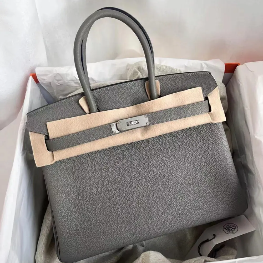Side angle showing structured silhouette of Hermes Birkin 30 Grey