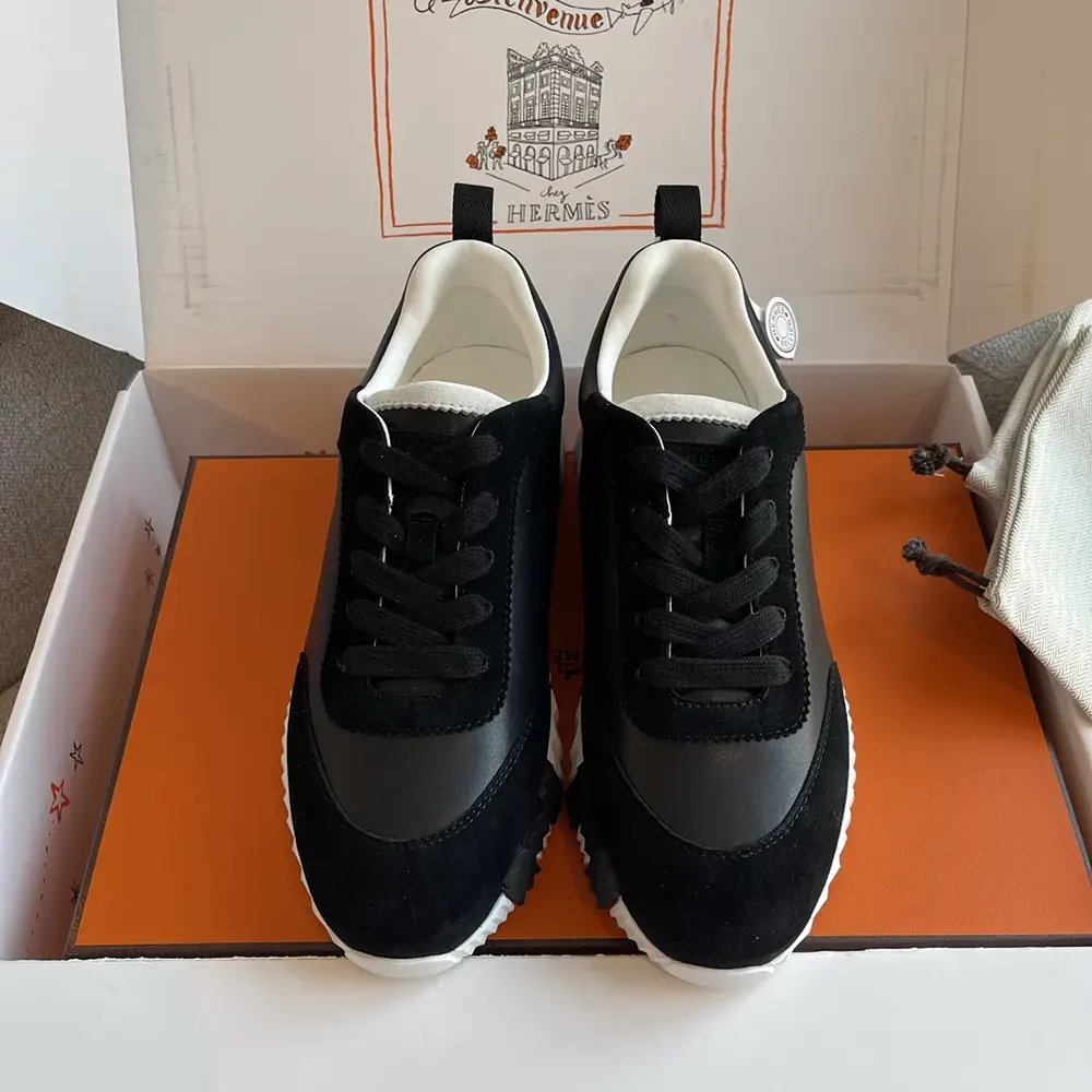 Close-up on black leather and Hermes logo hardware detail