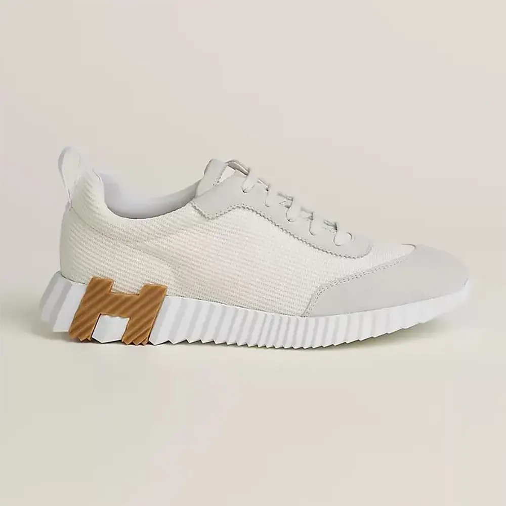 Side profile of Hermes Unisex Bouncing Sneaker-White/Brown showing leather texture