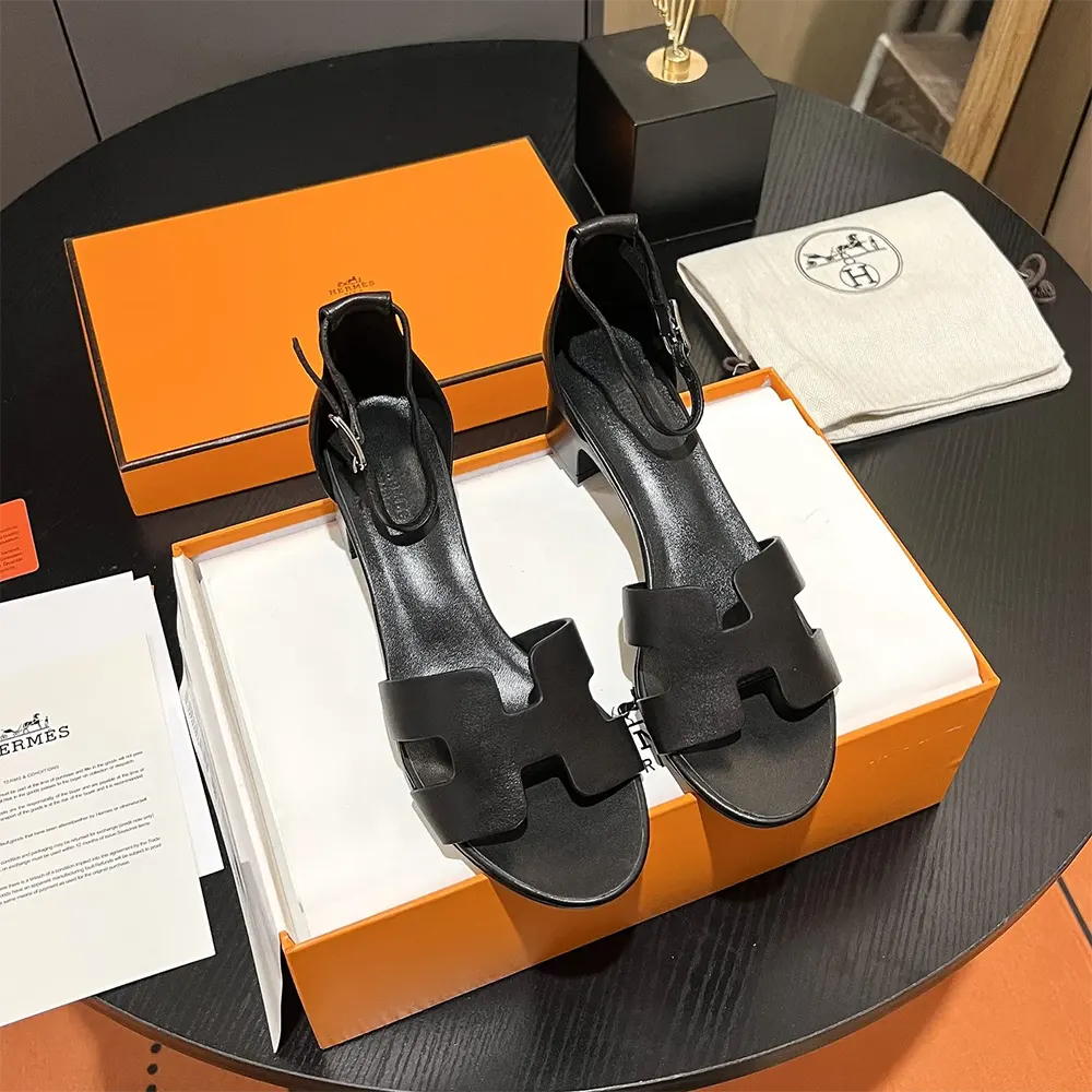Close-up of black leather and buckle on Hermes Women Encens 50 Sandal-Black