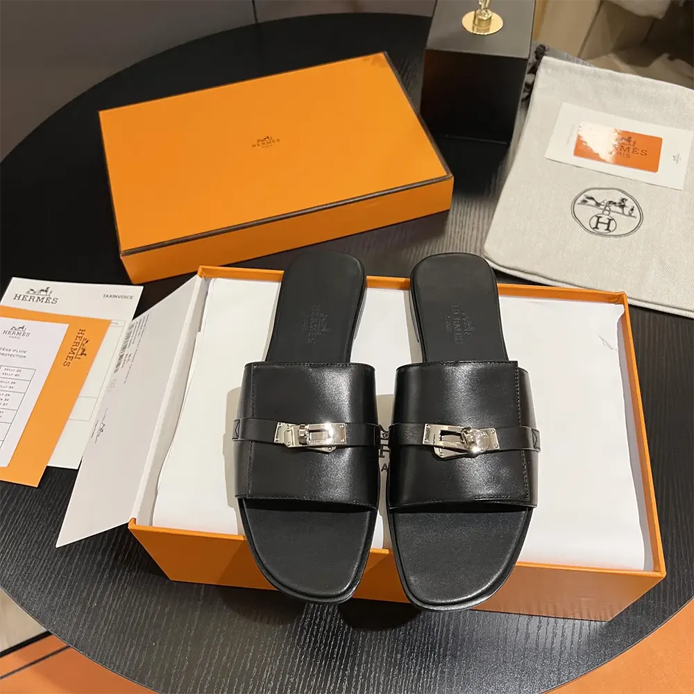 Close-up of silver-tone buckle detail on Hermes Women Giulia Sandal-Black