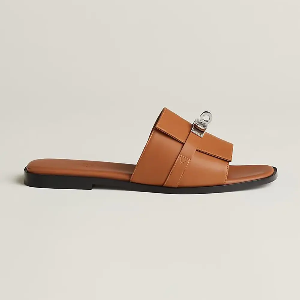 Side angle of Hermes Women Giulia Sandal-Brown showing ‘H’ cutout detail