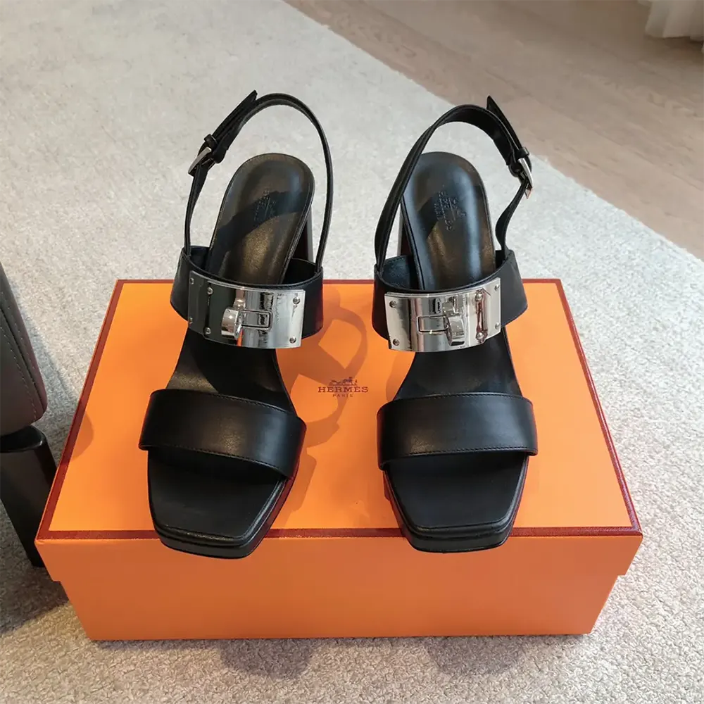 Close-up of black calfskin leather and signature hardware on Hermes Women Ilona 90 Sandal-Black